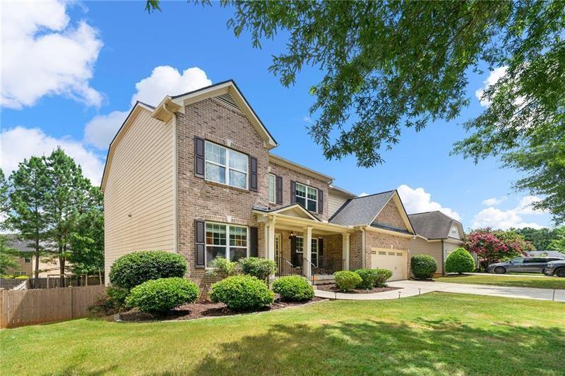 a front view of a house with a yard