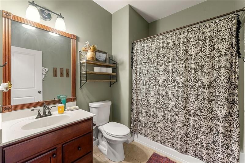 4970 Creekside Lane Powder Springs, GA 30127 - Photo 18 of 45 a bathroom with a sink toilet and shower