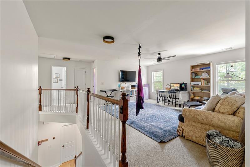 4970 Creekside Lane Powder Springs, GA 30127 - Photo 20 of 45 a living room with furniture and a flat screen tv