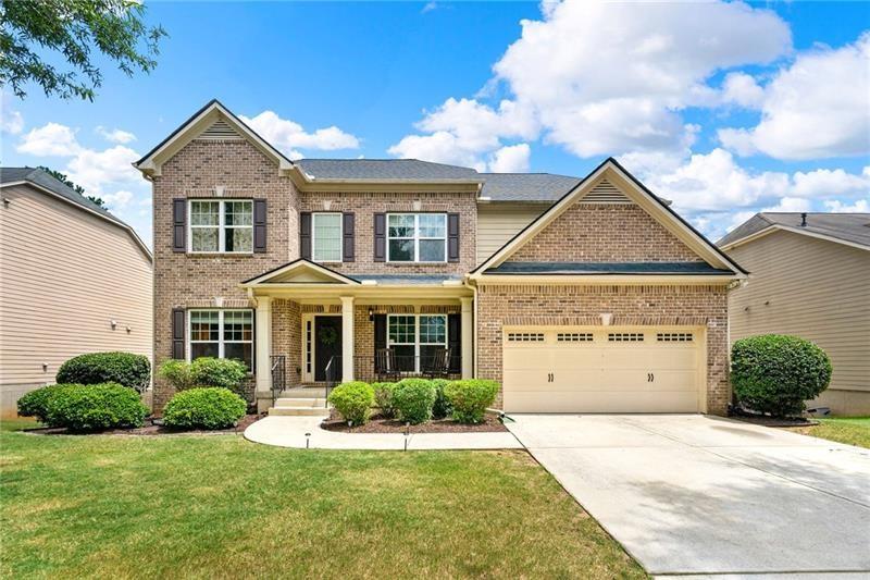 4970 Creekside Lane Powder Springs, GA 30127 - Photo 2 of 45 a front view of a house with a yard and garage