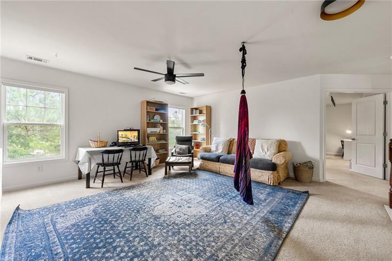 4970 Creekside Lane Powder Springs, GA 30127 - Photo 21 of 45 a living room with furniture a rug and a window