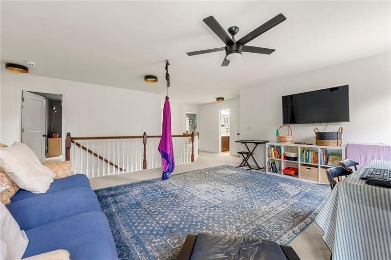 4970 Creekside Lane Powder Springs, GA 30127 - Photo 23 of 45 a living room with furniture and a flat screen tv