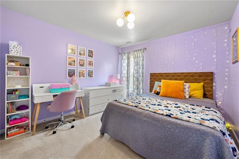 4970 Creekside Lane Powder Springs, GA 30127 - Photo 26 of 45 a bedroom with a bed and a chandelier