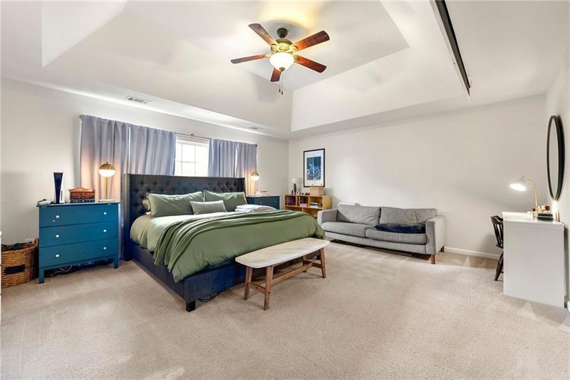 4970 Creekside Lane Powder Springs, GA 30127 - Photo 28 of 45 a bedroom with a bed and a chandelier