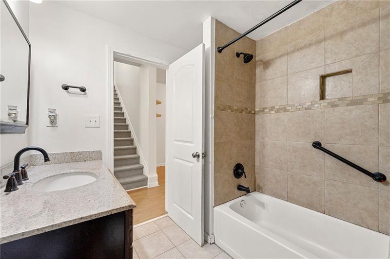 4970 Creekside Lane Powder Springs, GA 30127 - Photo 35 of 45 a bathroom with a sink and a shower
