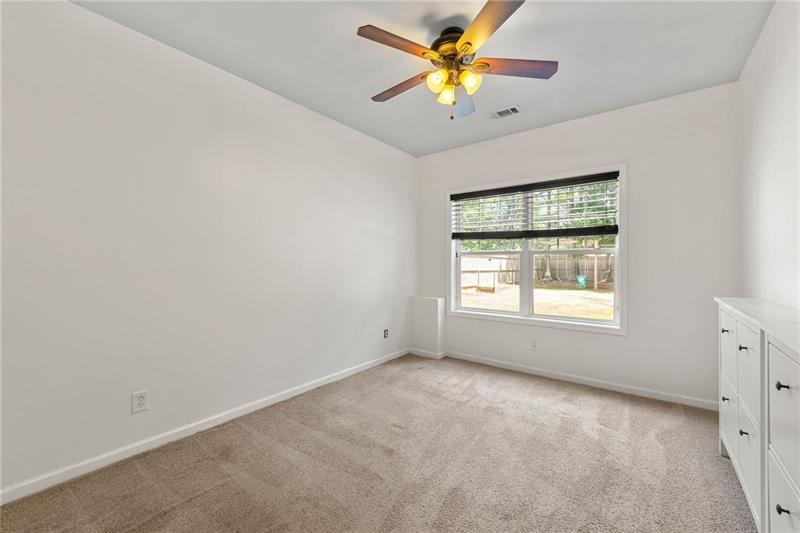 4970 Creekside Lane Powder Springs, GA 30127 - Photo 36 of 45 an empty room with a window and a fan
