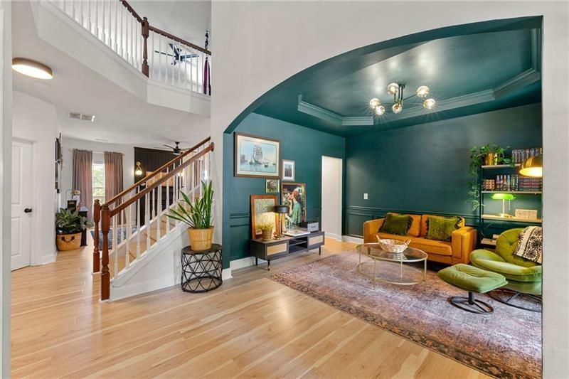 4970 Creekside Lane Powder Springs, GA 30127 - Photo 4 of 45 a living room with furniture and a chandelier
