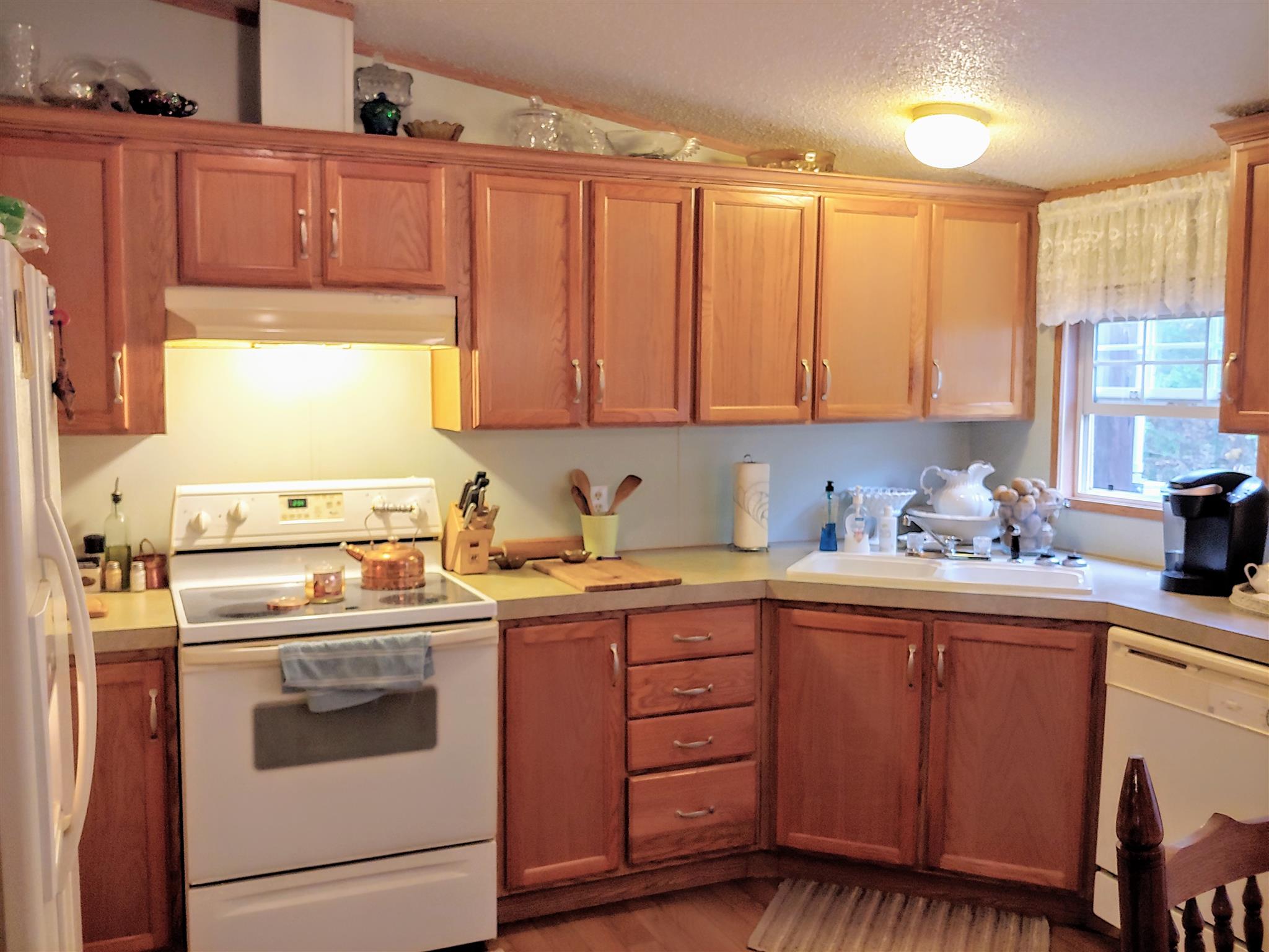 1235 Cunningham Road Readyville, TN 37149 - Photo 14 of 30 a kitchen with a sink stove and cabinets