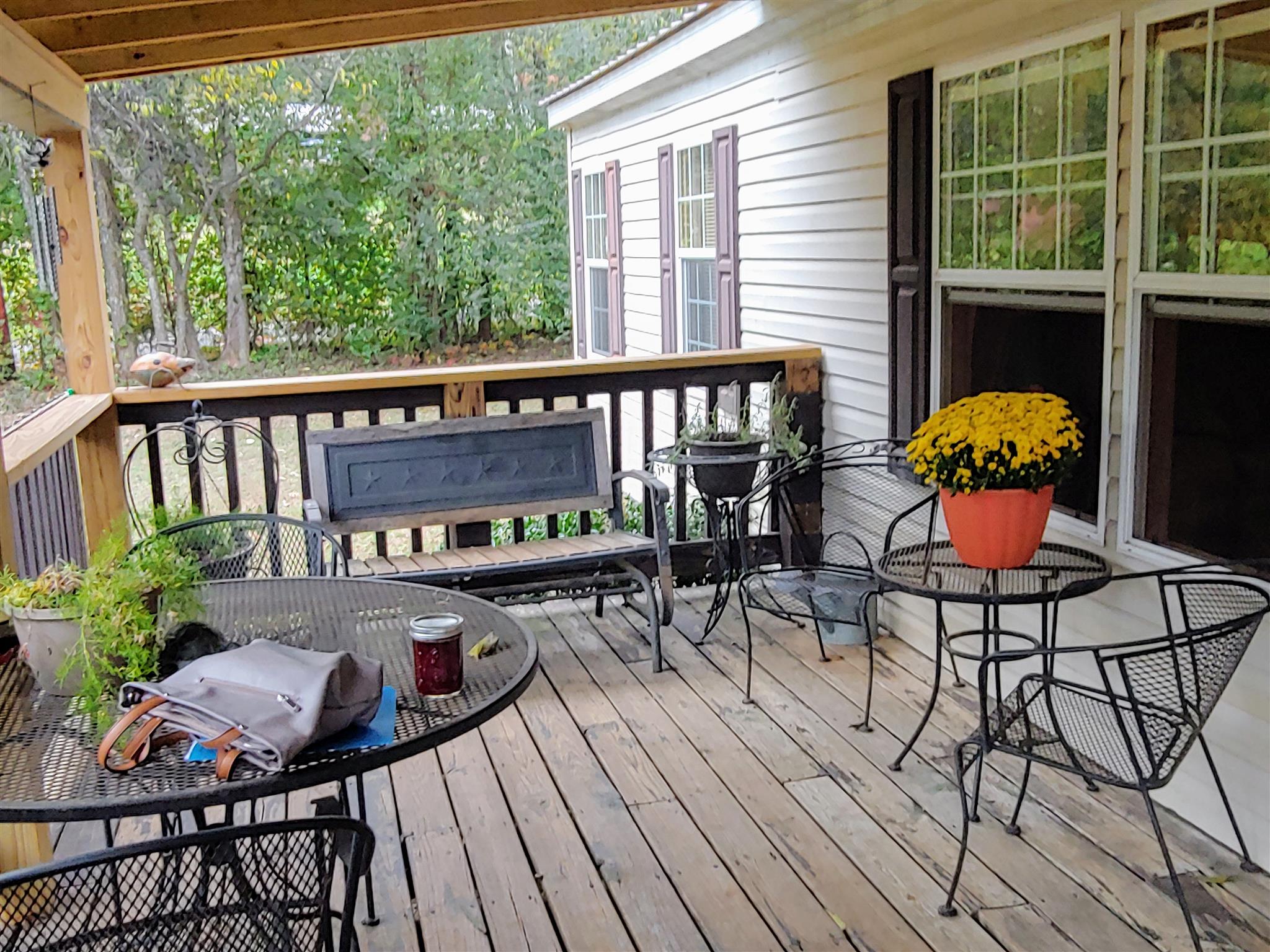 1235 Cunningham Road Readyville, TN 37149 - Photo 8 of 30 a view of a chairs and table on the deck