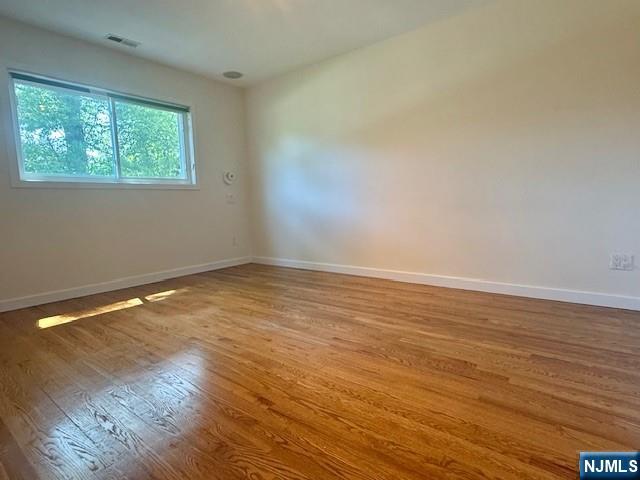 19 Center Street Cresskill, NJ 07626 - Photo 7 of 21 a view of an empty room with wooden floor and a window