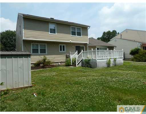4 Paddock Court Edison, NJ 08820 - Photo 2 of 23 a front view of a house with a yard