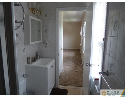 4 Paddock Court Edison, NJ 08820 - Photo 17 of 23 a bathroom with a sink and mirror