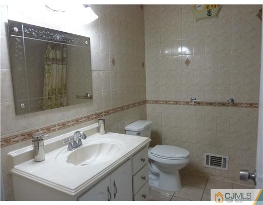 4 Paddock Court Edison, NJ 08820 - Photo 21 of 23 a bathroom with a sink toilet and mirror