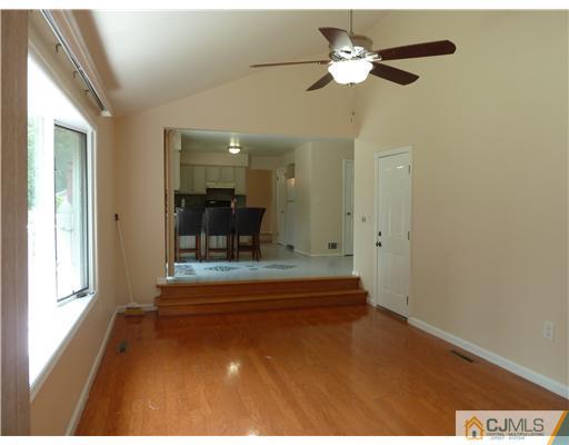 4 Paddock Court Edison, NJ 08820 - Photo 7 of 23 a view of a living room with a chandelier fan and kitchen view