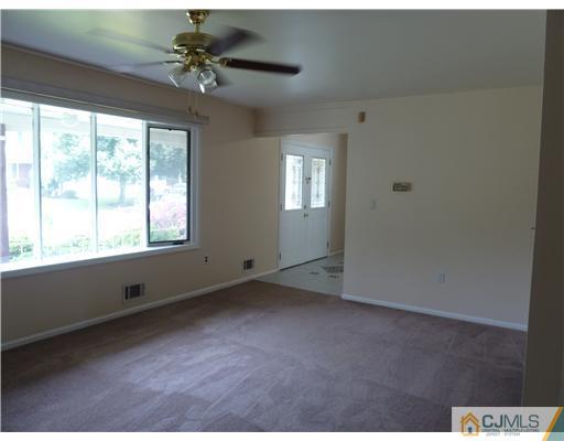 4 Paddock Court Edison, NJ 08820 - Photo 8 of 23 a view of an empty room with a window