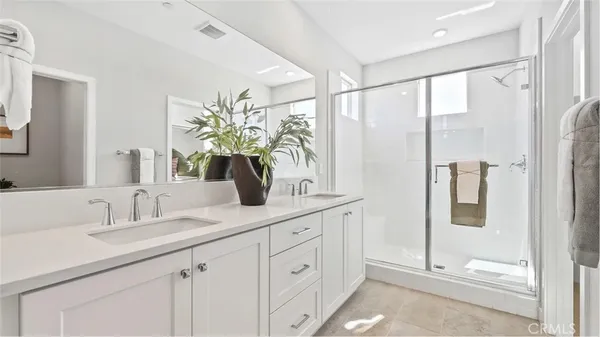 a bathroom with a double vanity sink and mirror
