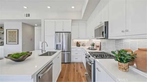 a kitchen with a sink and refrigerator
