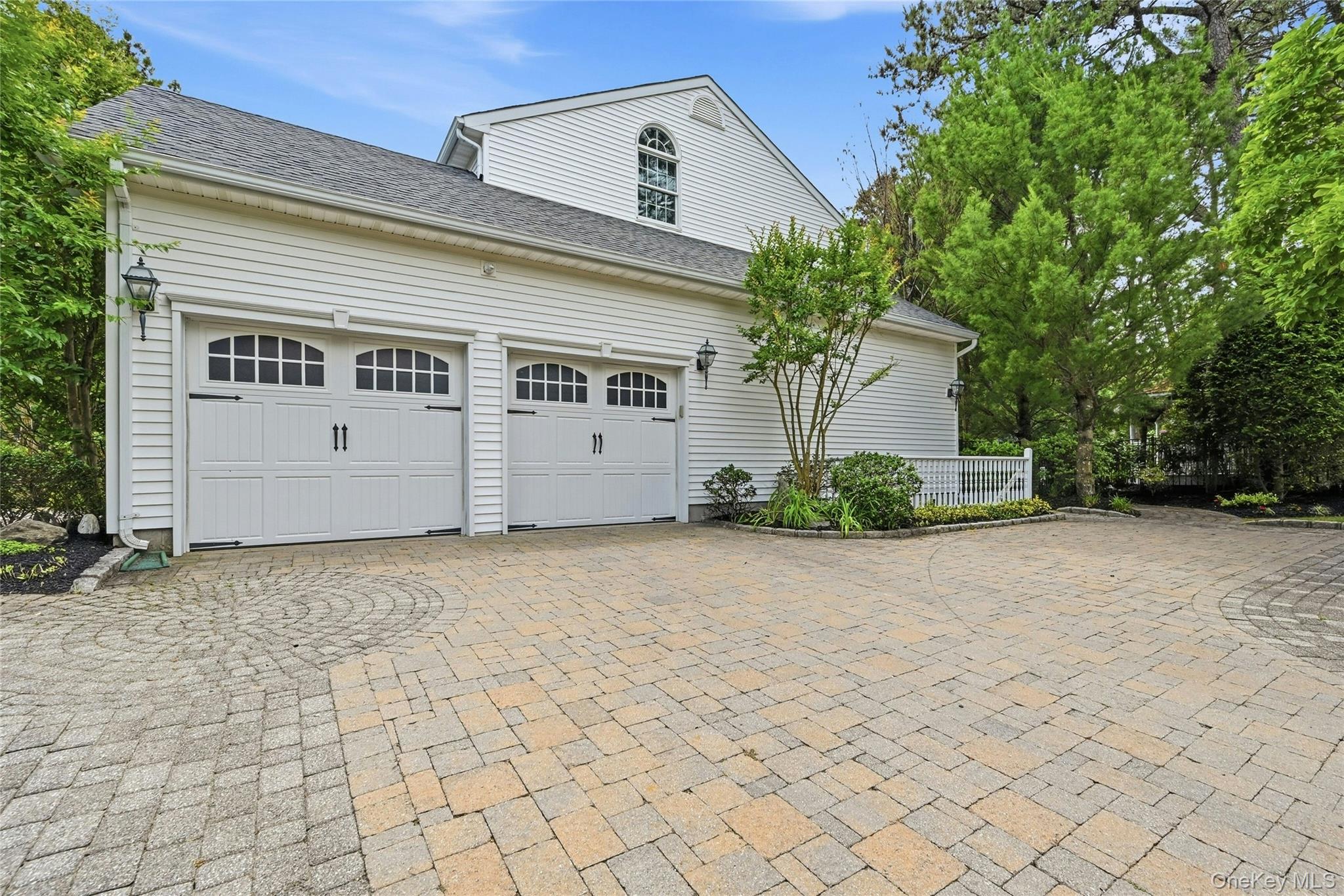 6 Thunder Road Miller Place, NY 11764 - Photo 8 of 50 The Side Of The Home Offers Access To The Two Car Garage With A Second Oversized Belgium Block Lined Fully Paver Stone Driveway With Additional Side Parking Area, Beautiful Inlays And Decorative Borders, An Outside Entrance To The Basement And Access To The Backyard.
