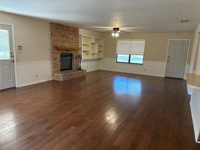 a view of a kitchen with granite countertop wooden floor and stainless steel appliances