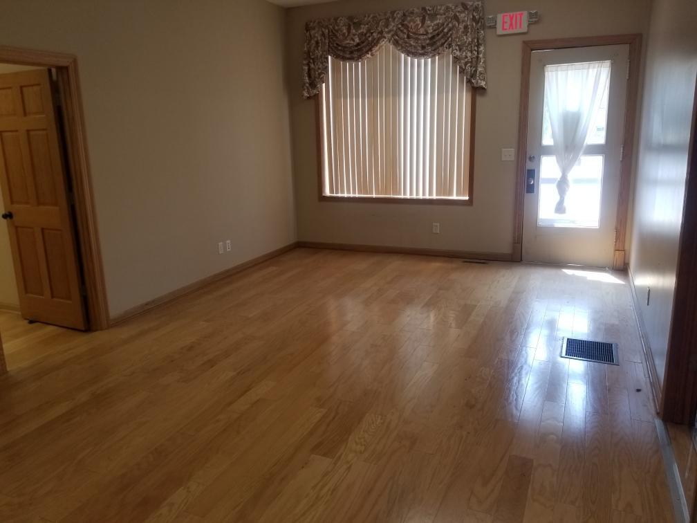 801 2nd Street LaSalle, IL 61301 - Photo 7 of 9 an empty room with wooden floor and windows