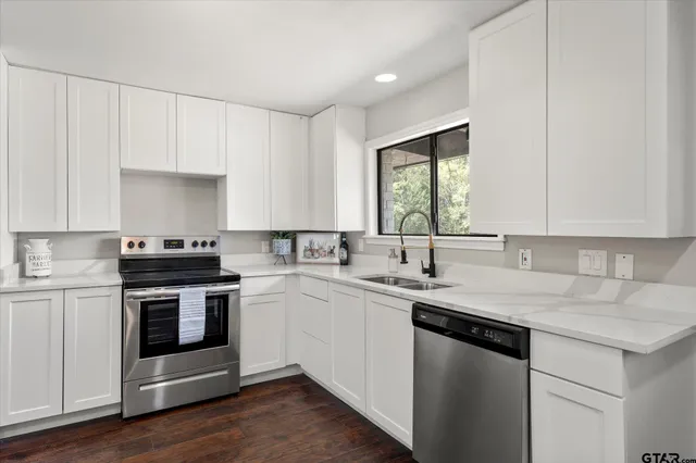 a kitchen with a sink stove and cabinets