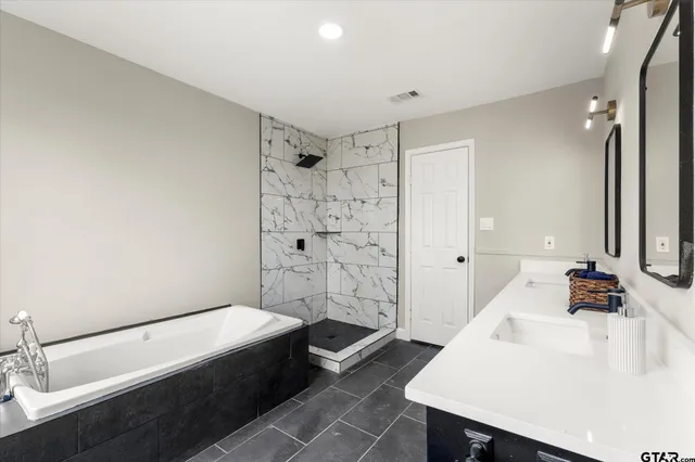 a bathroom with a bathtub and a sink