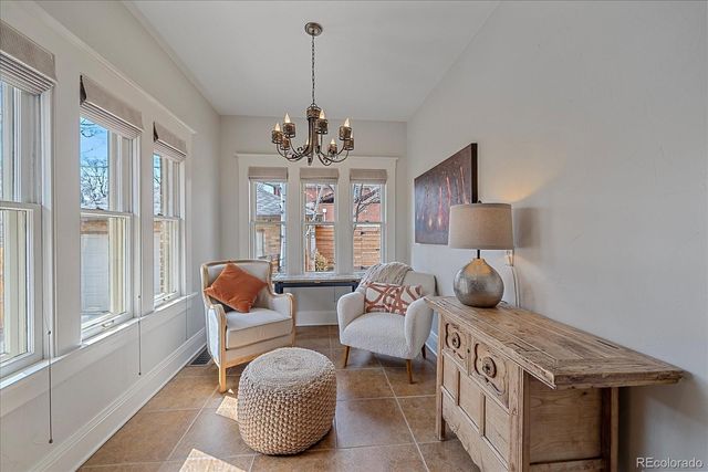 a bedroom with furniture and a large window