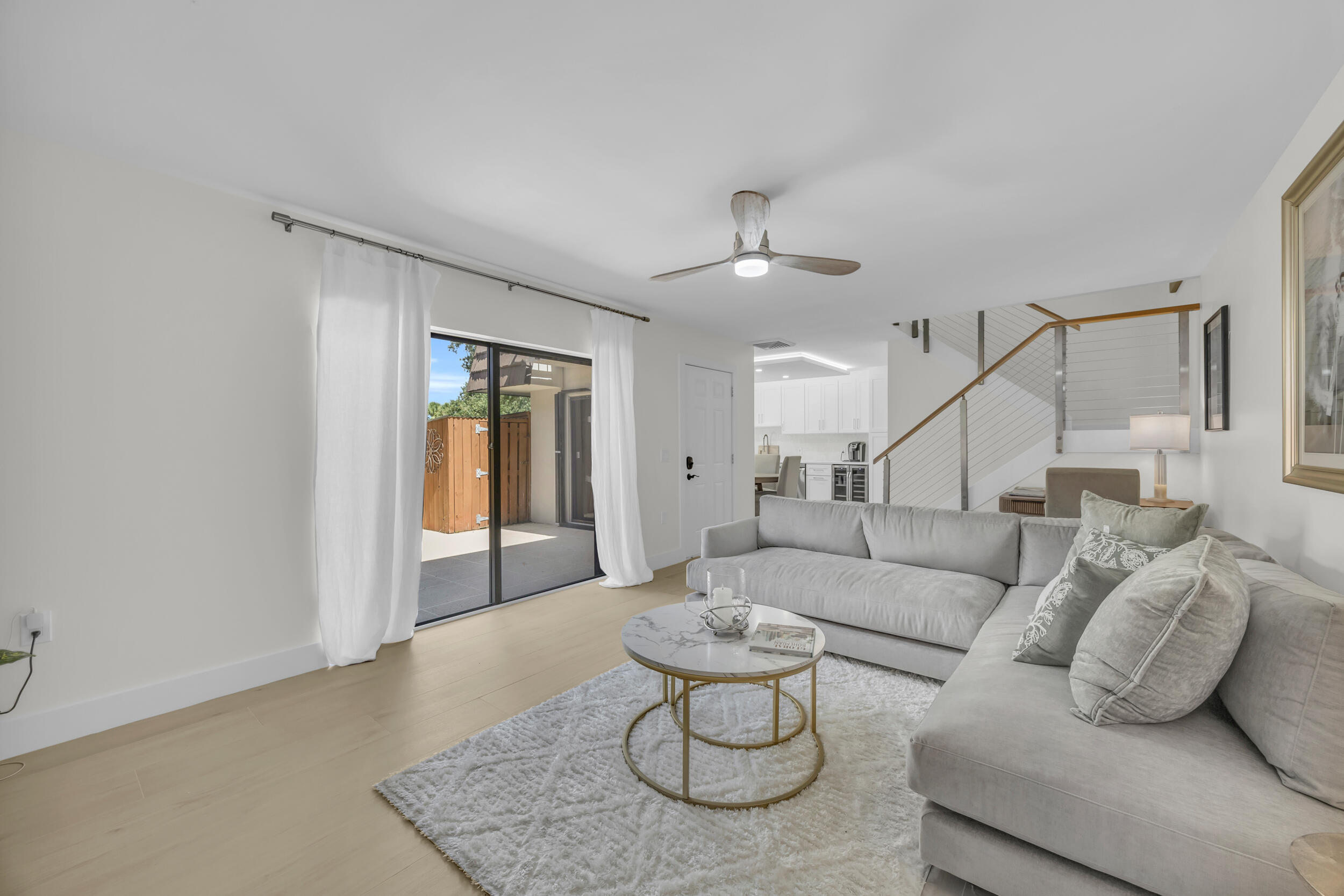 1208 12th Court Jupiter, FL 33477 - Photo 11 of 31 a living room with furniture and a ceiling fan