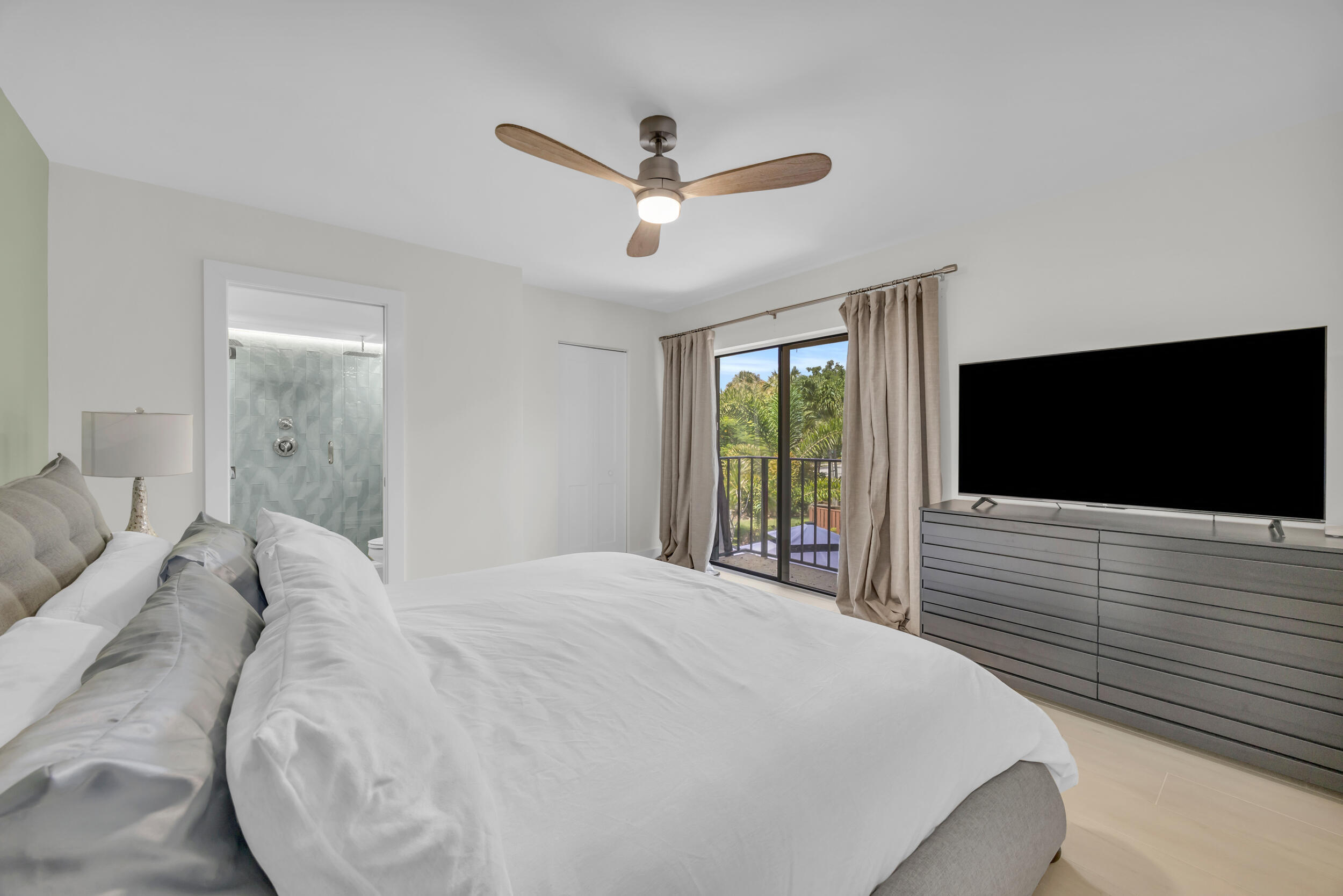 1208 12th Court Jupiter, FL 33477 - Photo 20 of 31 a bedroom with a bed and a flat screen tv