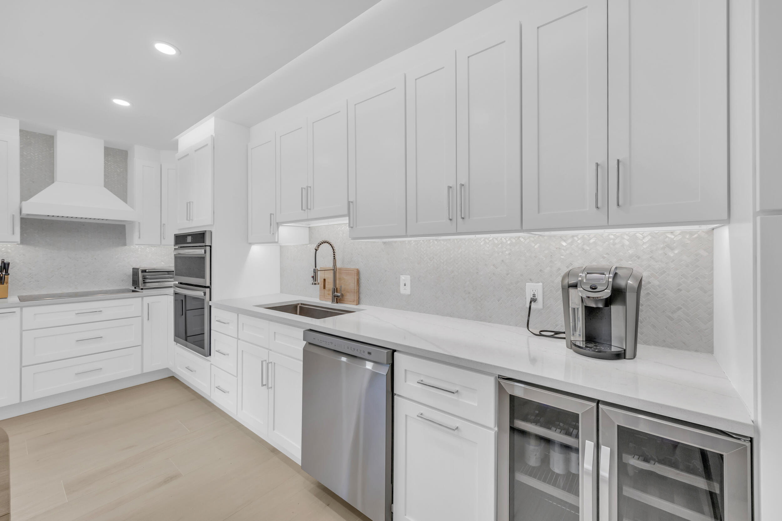 1208 12th Court Jupiter, FL 33477 - Photo 2 of 31 a kitchen with granite countertop white cabinets and white appliances