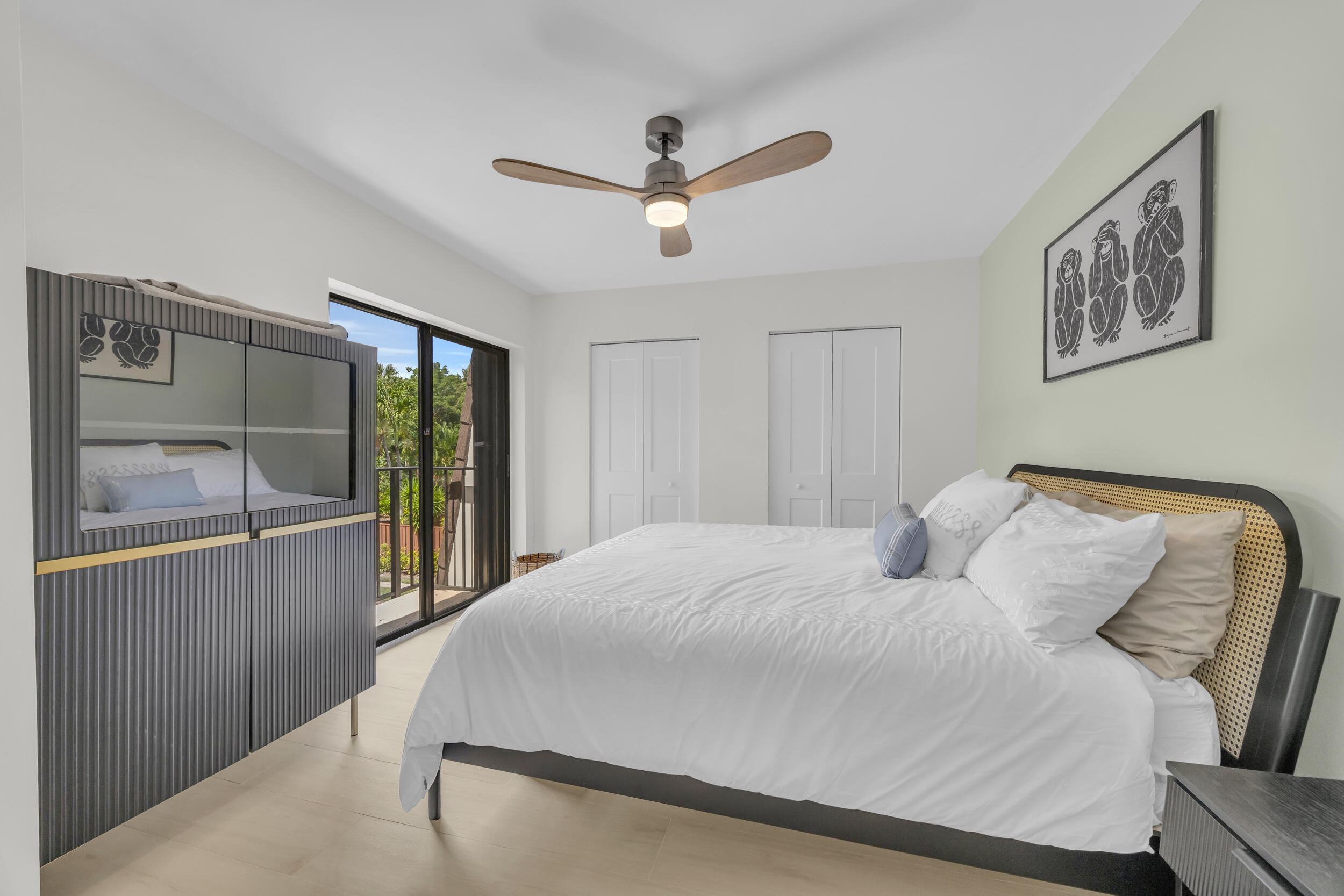 1208 12th Court Jupiter, FL 33477 - Photo 25 of 31 a bedroom with a large bed and a chandelier