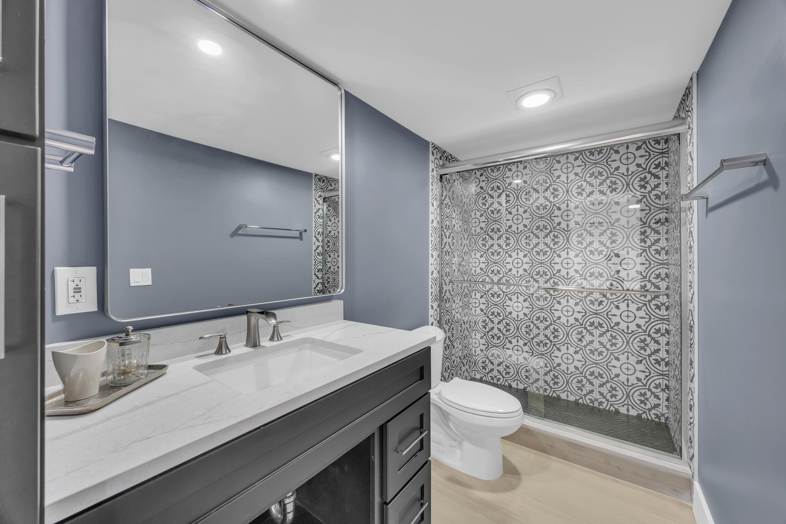1208 12th Court Jupiter, FL 33477 - Photo 26 of 31 a bathroom with a granite countertop sink a toilet a mirror and shower