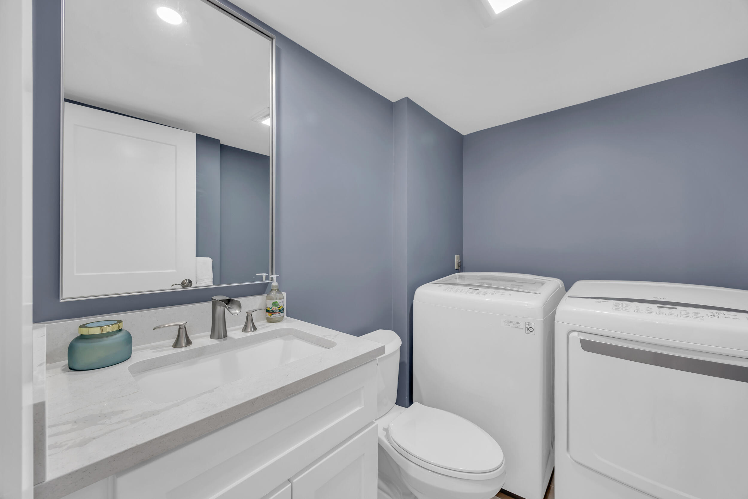 1208 12th Court Jupiter, FL 33477 - Photo 27 of 31 a bathroom with a sink a toilet and a mirror