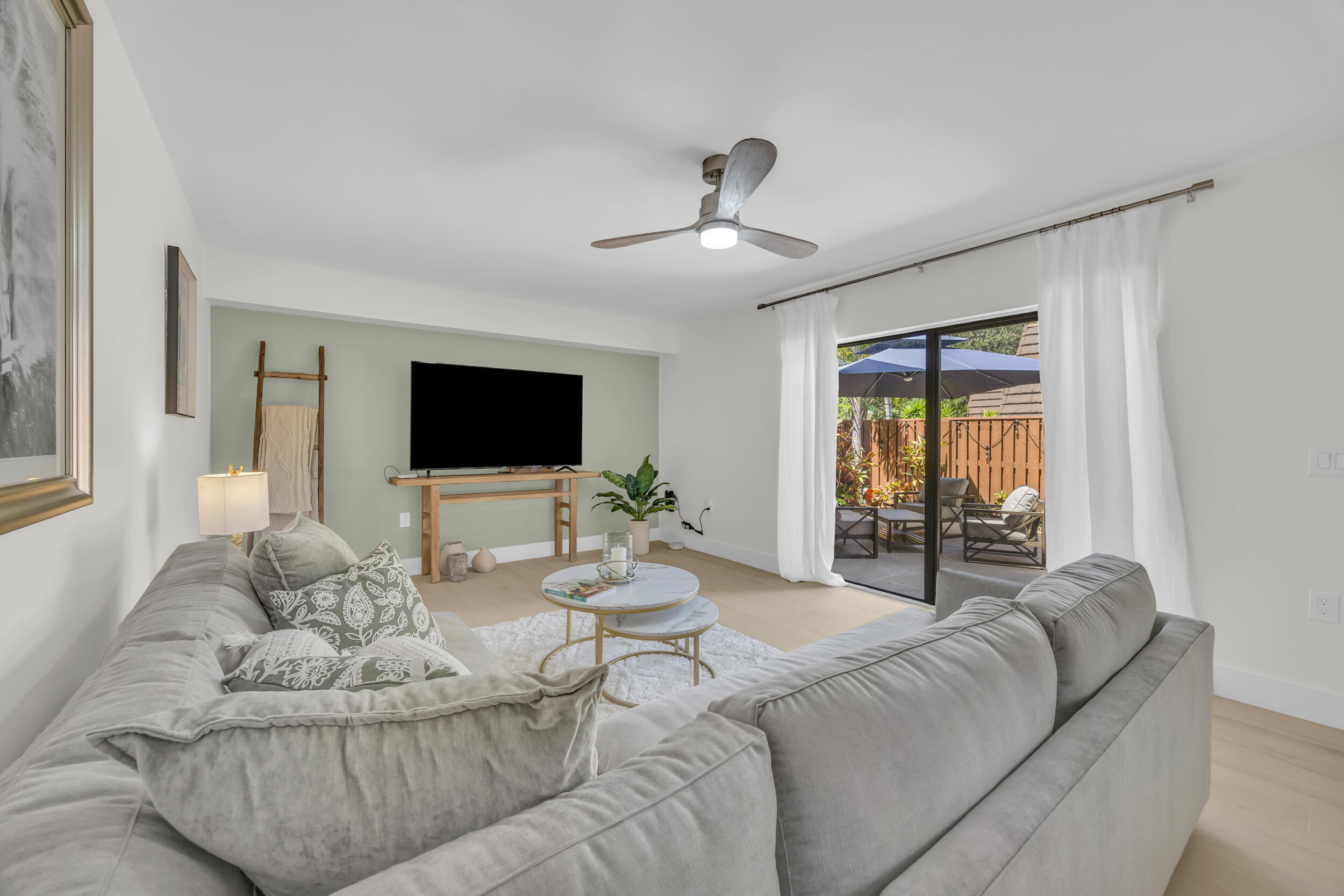 1208 12th Court Jupiter, FL 33477 - Photo 8 of 31 a living room with furniture and a flat screen tv