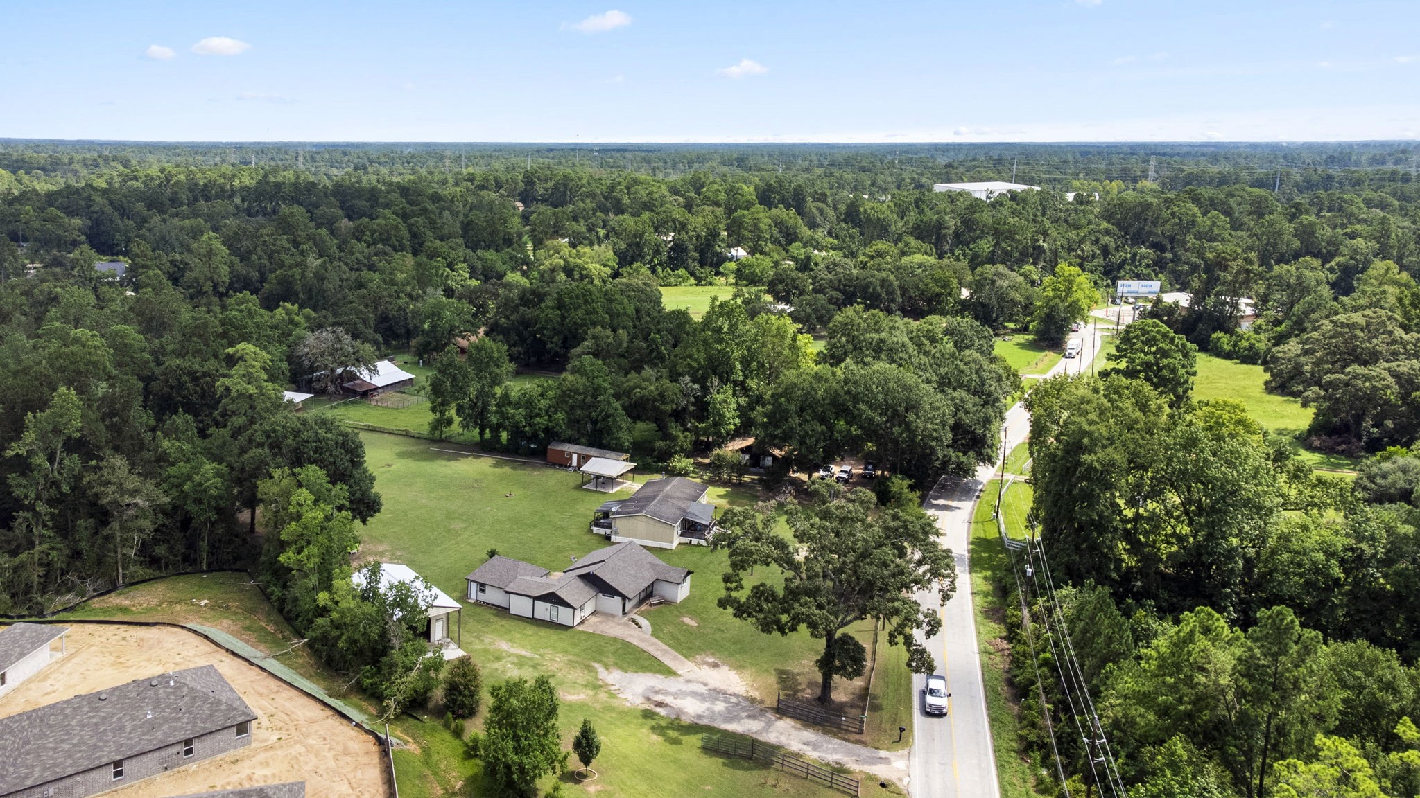 25311 Hardin Store Road Pinehurst, TX 77362 - Photo 35 of 39 an aerial view of green landscape with trees houses and mountain view