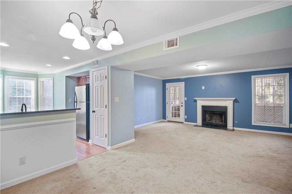 1485 Oakridge Court Decatur, GA 30033 - Photo 1 of 1 a view of an empty room with a fireplace and chandelier fan