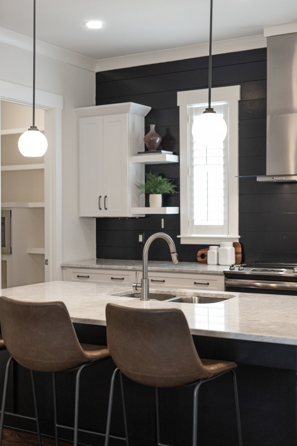 5543 Knob Road Nashville, TN 37209 - Photo 21 of 64 a kitchen with a dining table chairs sink and white cabinets