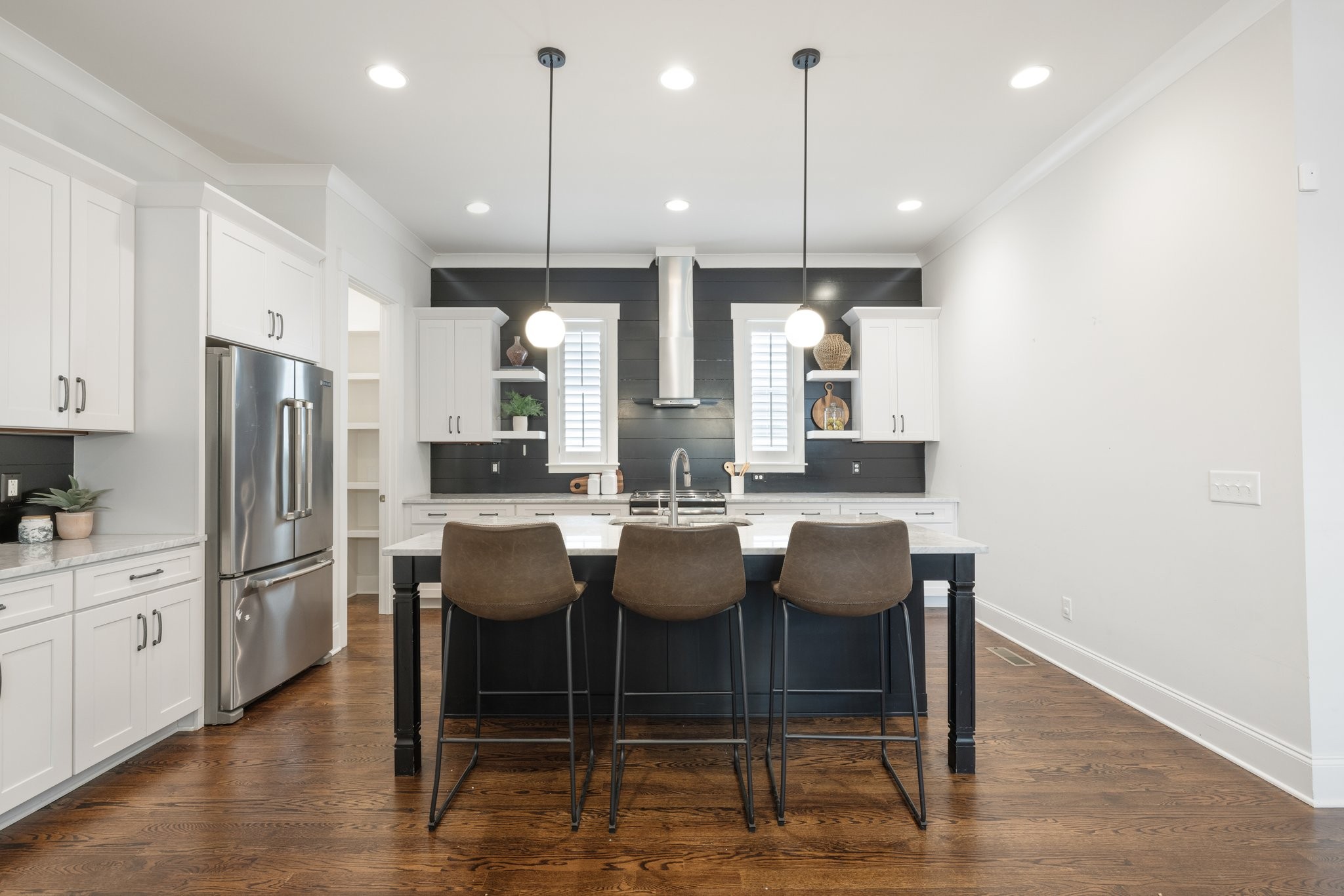 5543 Knob Road Nashville, TN 37209 - Photo 23 of 64 a dining room with granite countertop a refrigerator a stove a kitchen island with chairs and wooden floor