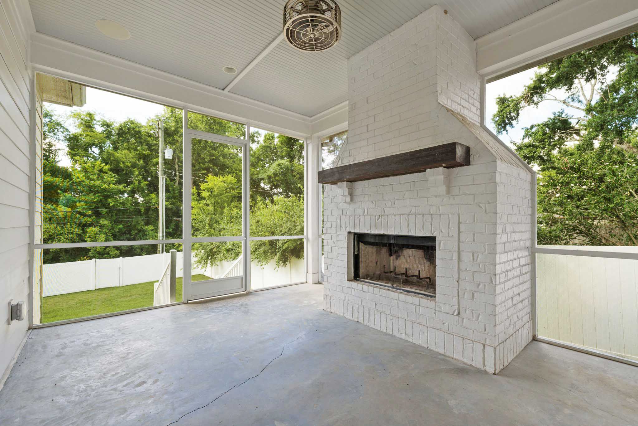 5543 Knob Road Nashville, TN 37209 - Photo 52 of 64 a living room with a fireplace and a floor to ceiling window