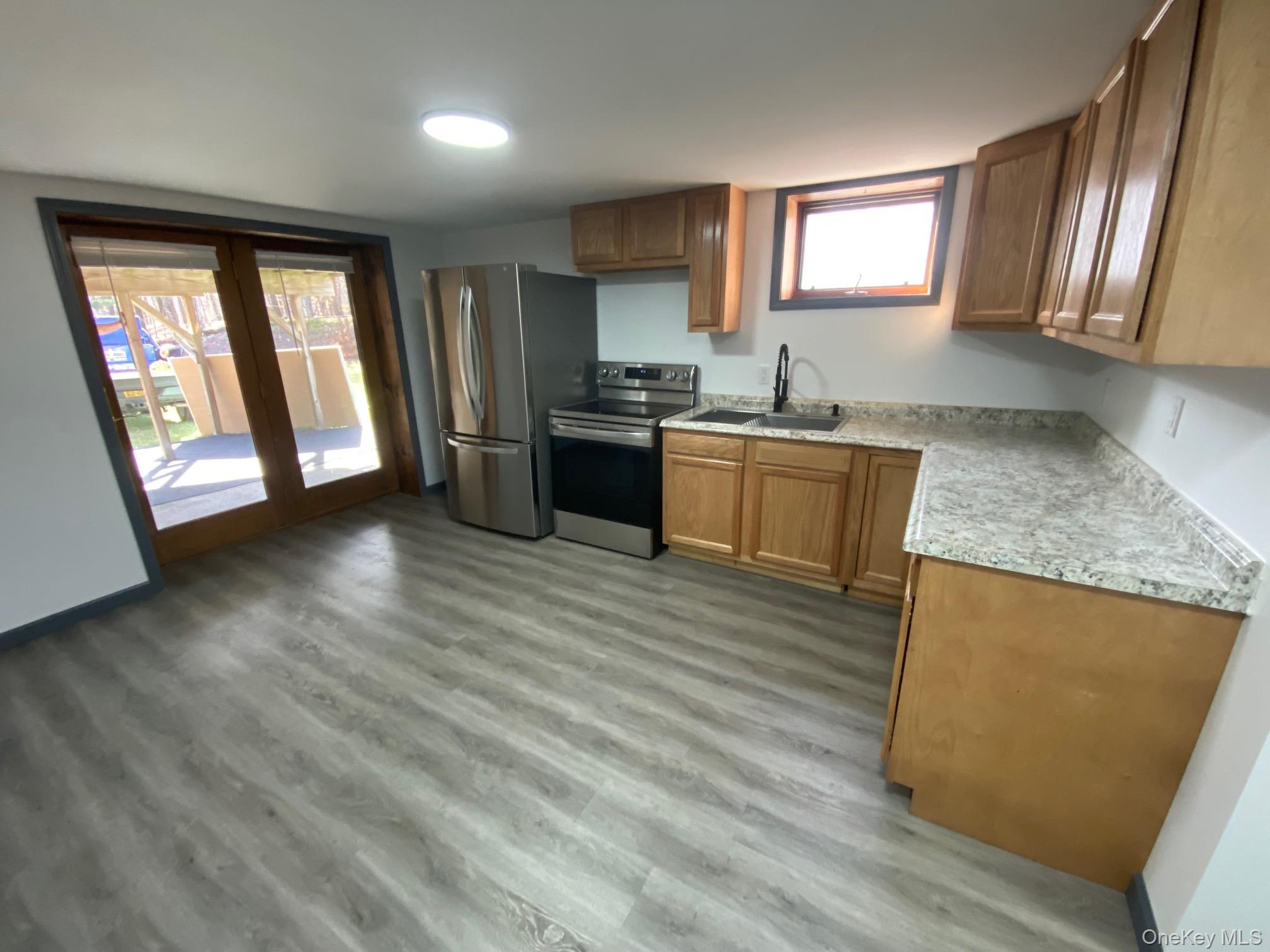 315 Upper Road, Unit LOWR Middletown, NY 10940 - Photo 3 of 9 Kitchen with light wood-type flooring, sink, and appliances with stainless steel finishes