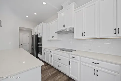 a kitchen with stainless steel appliances a refrigerator sink and cabinets