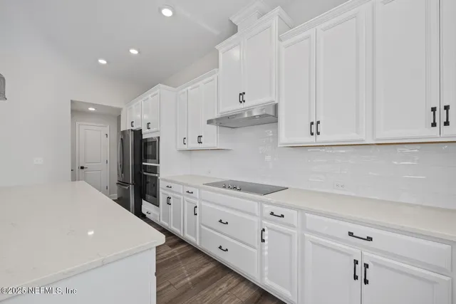 a kitchen with stainless steel appliances a refrigerator sink and cabinets