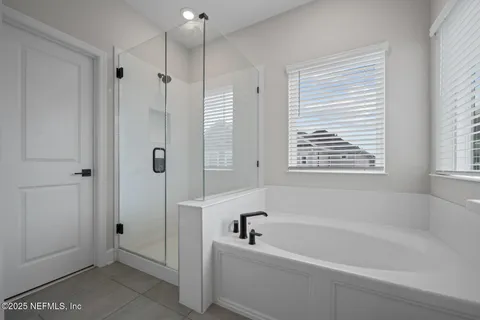 a bathroom with a bathtub and a shower