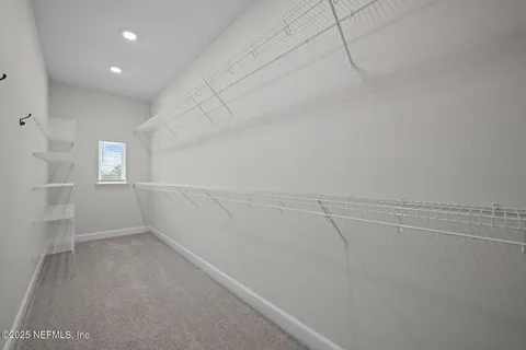 a view of an empty room with windows