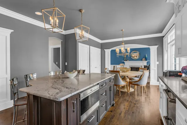 a view of a kitchen area with furniture and wooden floor