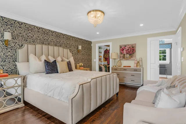 a bedroom with a bed and a chandelier