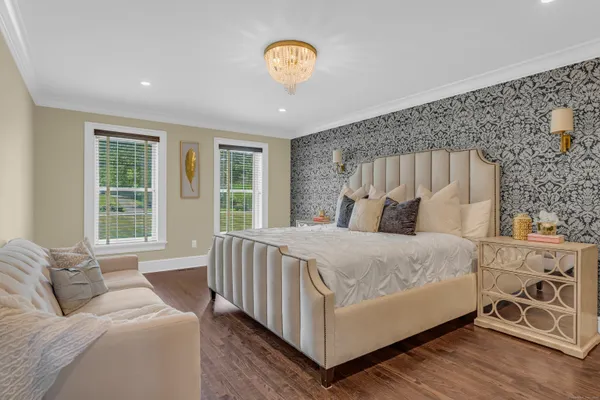 a bed sitting in a bedroom next to a window