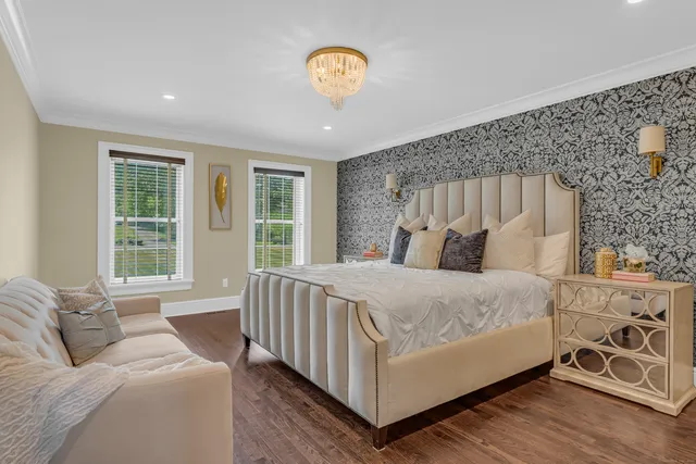 a bed sitting in a bedroom next to a window