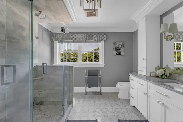 a bathroom with a double vanity sink toilet and shower