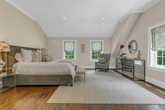 a bedroom with a bed a table and chair